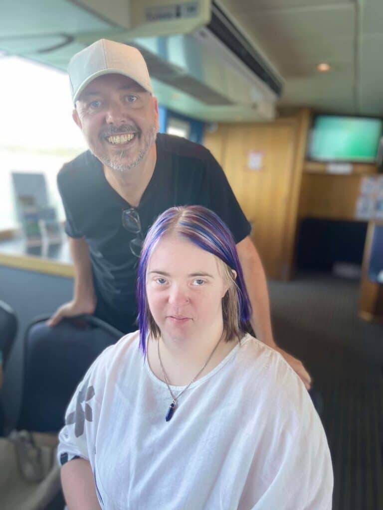 Two Smiling People in a Room — Gleam Support Services Pty Ltd in Weston, NSW