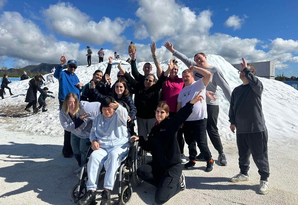 A Group Of Individuals Smiling And Posing