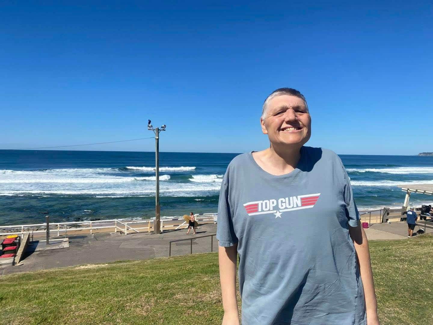 A Smiling Person With The Sea The Back