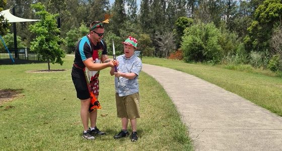 Man Teaching How To Use Bow — Disability Services in Weston, NSW
