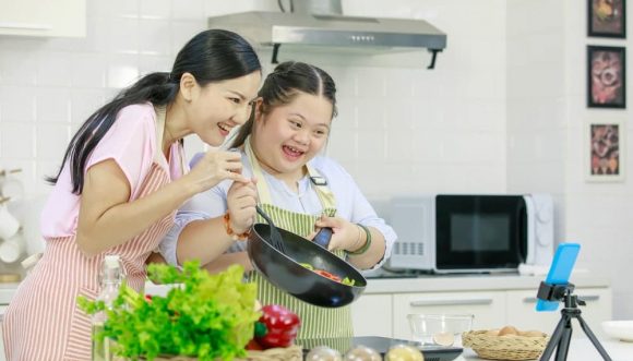 A Woman And A Girl Cooking Together — Gleam Support Services Pty Ltd in Weston, NSW