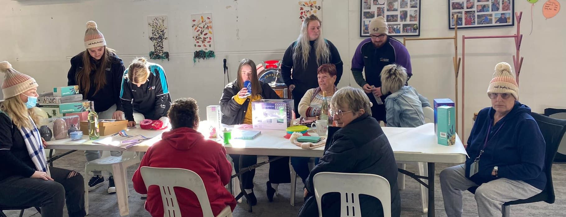 Group Of People Surrounding A Table — Disability Services in Weston, NSW