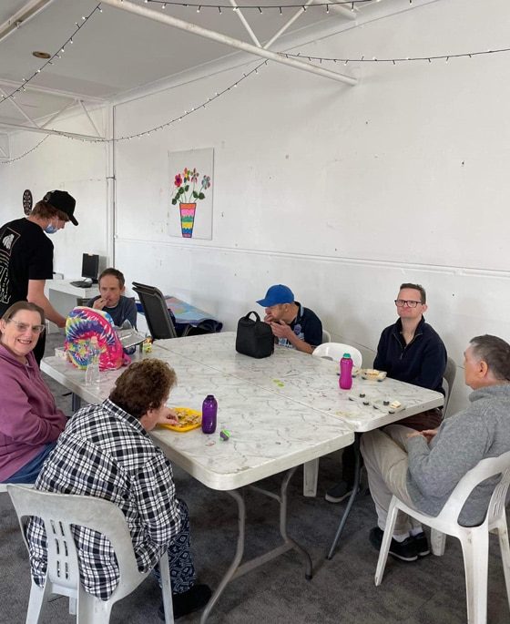 People Around A Table — Disability Services in Weston, NSW