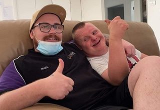 Men Sitting On Couch — Disability Services in Cessnock, NSW