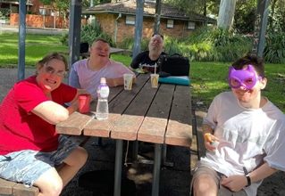 People Eating In A Park — Disability Services in Weston, NSW