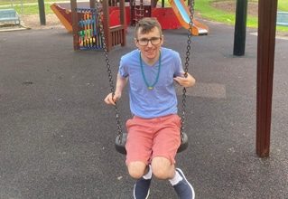Guy Riding A Swing — Disability Services in Weston, NSW