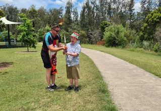Man Teaching How To Use Bow — Disability Services in Weston, NSW