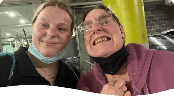Women Smiling On Camera — Disability Services in Cessnock, NSW