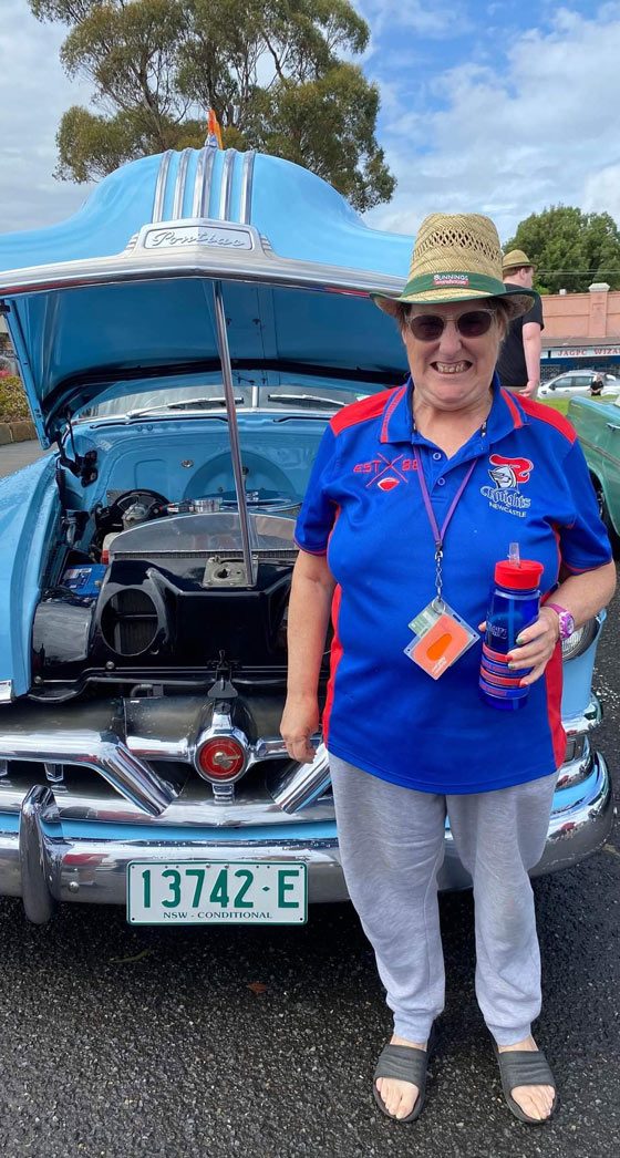 Woman In Front Of A Blue Car — Disability Services in Weston, NSW