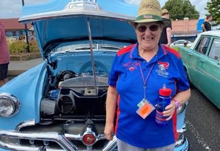 Woman In Front Of A Blue Car — Disability Services in Weston, NSW