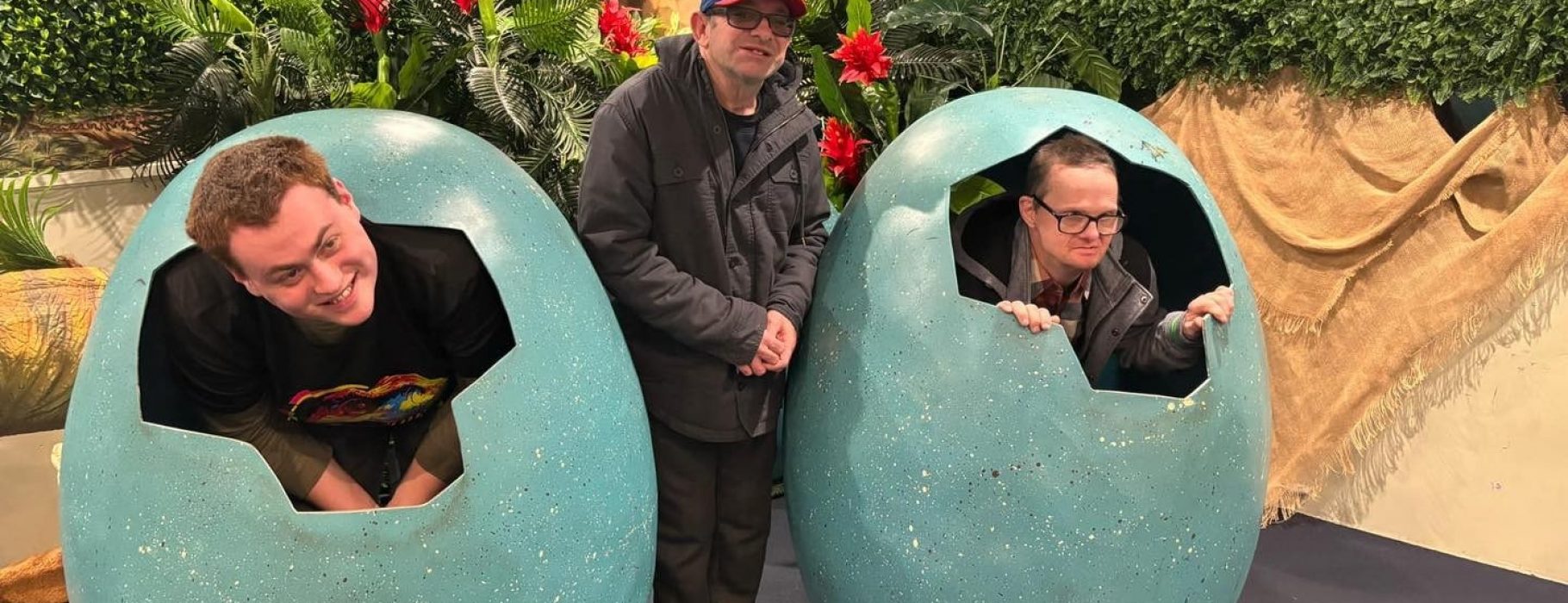 Three Smiling People in Front of a Bush — Gleam Support Services Pty Ltd in Weston, NSW