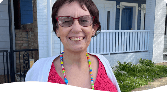 Woman Smiling Outside A House — Disability Services in Lake Macquarie, NSW