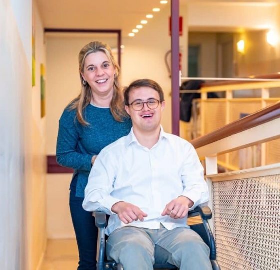 Man In A Wheelchair Smiles Next To A Woman On A Sunny Day Outdoors — Gleam Support Services Pty Ltd in Weston, NSW