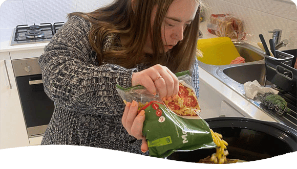 Woman Cooking Macaroni — Disability Services in Lake Macquarie, NSW